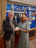 Kerry Banks from Martha Trust receives a cheque from President Jim Nicholson