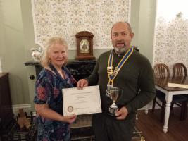 Mary receives Community Award for 2023  from President Shaun Yeoman