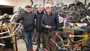 Mike Carson and Bertie Carson with one of the Bike Aid Africa staff at their refurbishment centre.