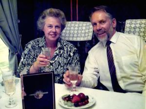 Paul enjoys a glass of bubbly with his lovely wife Hazel on the Orient Express.