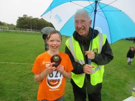 Rotary President, Mike Bunn, presents her award to Ellie Walsh who won the yrs. 5/6 girls race