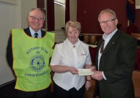 Salvation Army photograph: Rtn. Brian Smith with Rotary Club President Tim Skinner, presenting a cheque to Salvation Army Major Jean McDevitte in the Salvation Army Hall at Stour Road, Christchurch