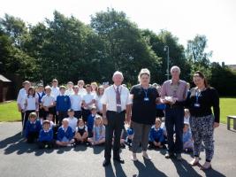 The photo shows, from left to right, Judith Markey (Chairman of Governors at Beaconside), the Beaconside School Ghana choir led by Emma Short as part of the fundraising effort for the Ghana trip,  Peter Markey, Emma Short, Pres David and teacher Sarah Ut