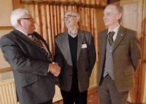 President Brian welcomes our newest member Peter Wykes and shares a joke with him and  proposer John W.
