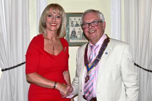 President Michael is congratulated by Past President Julie.