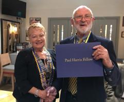 Bernard Paull receives his Paul Harris from President Chrissie