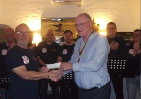 President James Slinn thanks the Pett Slip Bouys for their entertaining singing and presents cheque towards funds.