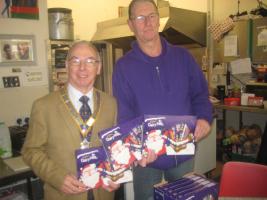 Simon at Open Door presenting chocolate packs for them to distribute at Christmas.