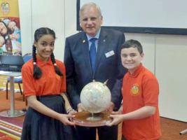 Jack presenting the trophy to Darnley Primary School