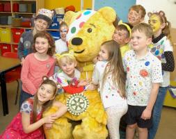 Pudsey with children from Witney Community Primary School