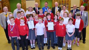 Redby Rotakids with their charter and Rotarians