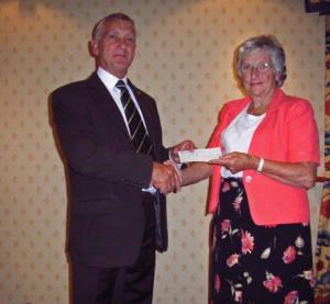 International Chairman Colin Brown presents cheque to Judy Lindgren for Msambweni Youth Group
