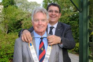 Outgoing President Neil Spriddle pins the President's chain on John Stirling, President of the Rotary Club of West Fife 2018-2019