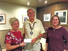 Rebecca and Ruth Receiving a donation from President Nigel