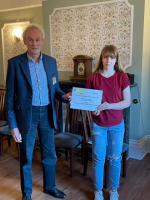 Rotary Assistant District Governor Richard Perkins presents District Award to Bethany Jeal