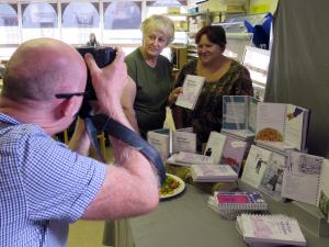 Andrea Birch, left, and Carolyne Stevenson-Jones, Designs In Mind members, get their picture in the Tizer at the launch of 