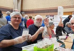 Club members taking part in the annual event to pack meals for children in third world countries.