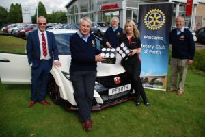 Rotary members inspecting the super Honda type R sports car which features in the Win-a-Car competition at Perth Rotary Club's Charity Fayre in Perth High Street on Saturday 29 August"
