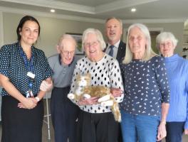 Residents, staff and Rotarians surround star of the day Rufus