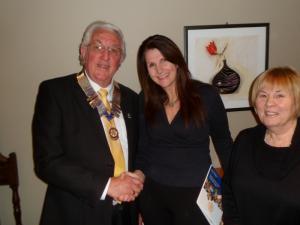 Melanie Evans being welcomed into Rotary by President Ian Kelly along with sponsor Liz Rowe