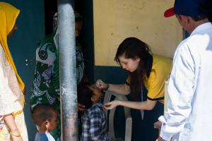 Member of Abingdon's Interact Club (=Junior Rotary) immunising an Indian child against polio on Rotary's 110th birthday. Photo taken from her camera.