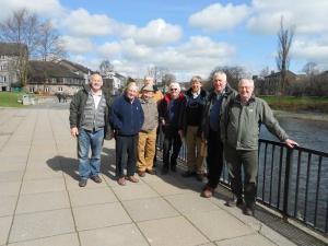 A few walkers by the banks of the river Kent in Kendal