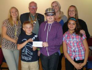 Sefton Young Carers receive a cheque for their forthcoming trip