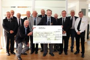 A Group of Club Members with a large version of teh Bonus Cheque
