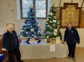 Jane and Hilary by their decorated Christmas Trees 