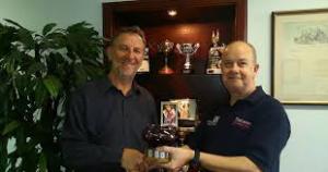 Photograph shows (L-R) Roland receiving the Pentti Airkkala trophy from Andrew Pemberton.