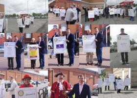 Members and friends carrying Sandwich Boards advertising local businesses.