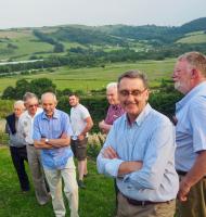 Bryn and some of the members present admiring the growing vines 