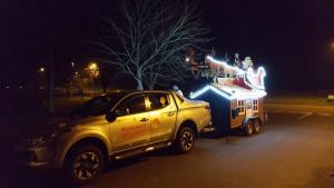 Car and trailer with Father Christmas