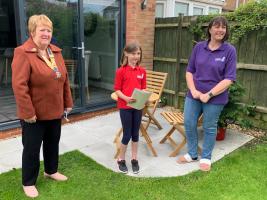 Young Writer Amelie, with her Girls' Brigade Captain, being presented with her Highly Commended Certificate by Club President, Judy Webb.