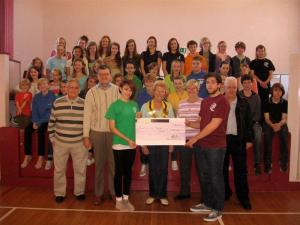 The members receiving the cheque are Harley Mackness and Michael Pearl.