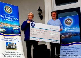 Mike Kirkham, President of Paignton Rotary, presents a cheque for £1,540 to Martin Brook, Director of THHN.