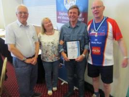 Alan and his wife receiving award from District Governor Stephen Lay (sorry about dress!) with Roborough Rotary's President Elect Peter Norton