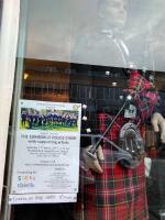 Concert poster in the window of Top Hat - the place to go for top class kilts.