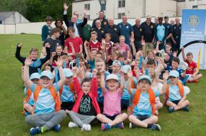 Arthur Jones, District Governor 2015-16, making the £3000 presentation, with a host of excited children.