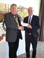 President Ian Birelll presenting a cheque to Canon John Ellis.