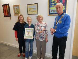 Local artist, Anne Jackson presents a cheque for £415 to Dunbar Rotary Club President Robin Hamilton at Dunbar’s new Community Centre. L to R.  Successful bidders Nicola and Emma Lonie, Anne Jackson and Robin Hamilton.