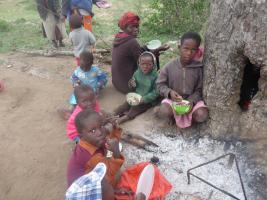 Children eating under a tree