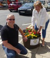 Prestwick Rotary President Stephen Cooper is shown, with Rotarian Edith Sterrick, tending a tub