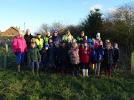 Local school children helping plant trees.