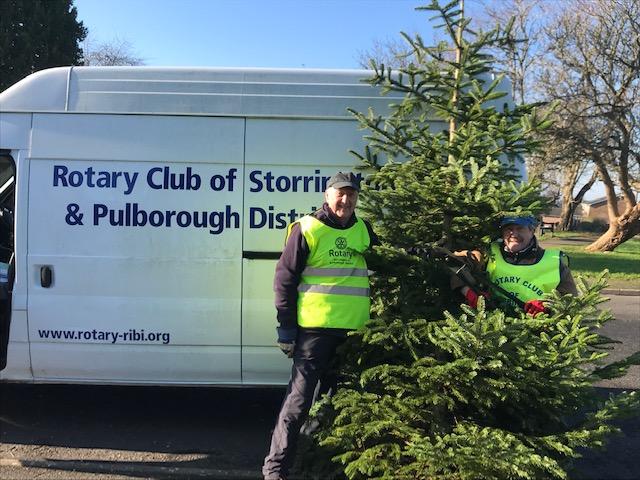 Rotarians Ken Collins and Mike Webster collecting Christmas trees