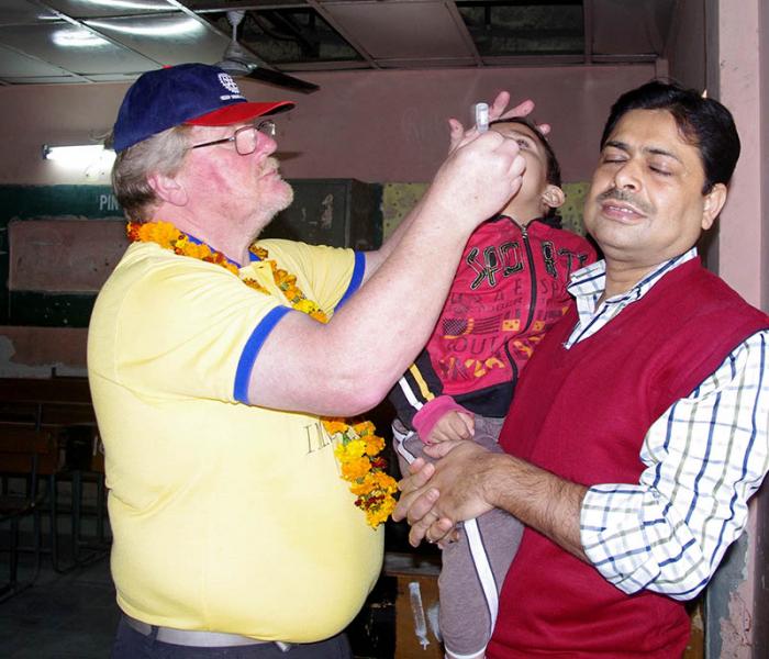 October 24th is World Polio Day - Guy & Gill join Rotary's Polio Immunisation team in India - Guy delivering some of the drops to a child.