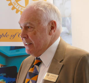 A grey-haired man wearing a Rotary name badge