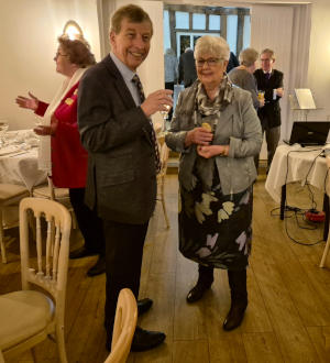 A man and a woman standing in a restaurant