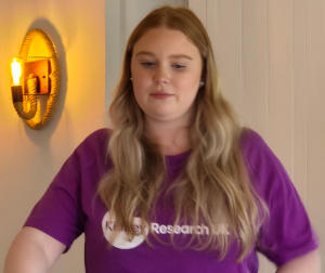A young woman with long blonde hair wearing a kidney Research UK T-shirt