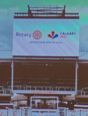 A large banner situated in a stadium, referring to Rotary's Grandstand Spectacular